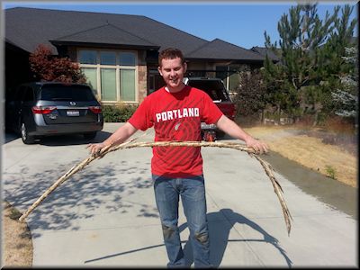 My son holding a piece of broken PVC pipe